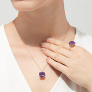 The 14K Rose Gold Amethyst and Diamond Pendant, 6.62 TCW, features a cushion-cut amethyst with diamond accents in a four-prong setting and is elegantly displayed on a white background.