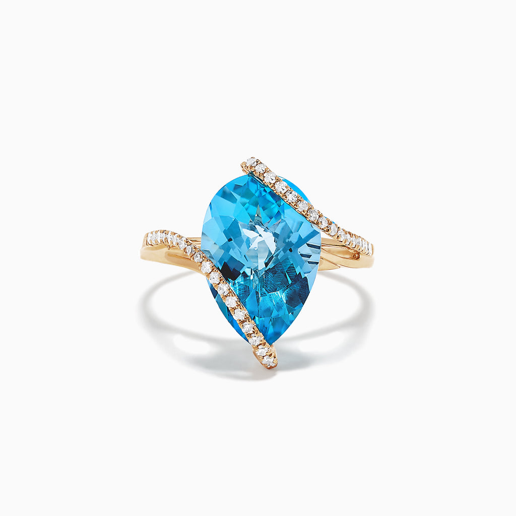 The Ocean Bleu 14K Yellow Gold Blue Topaz and Diamond Ring (6.28 TCW) features a large pear-shaped blue topaz accented by wavy rows of sparkling diamonds crossing over the stone, displayed on a plain white background.