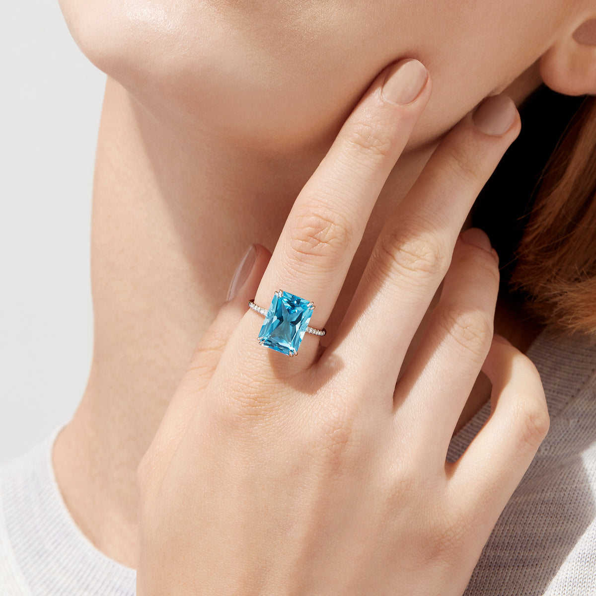 The Ocean Bleu 14K White Gold Blue Topaz and Diamond Ring, 8.06 TCW, showcases a large rectangular blue topaz center with sparkling diamonds along the band, displayed on a plain white background.