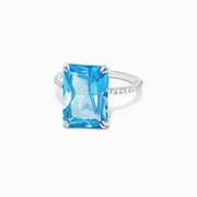 The Ocean Bleu 14K White Gold Blue Topaz and Diamond Ring, 8.06 TCW, showcases a large rectangular blue topaz center with sparkling diamonds along the band, displayed on a plain white background.