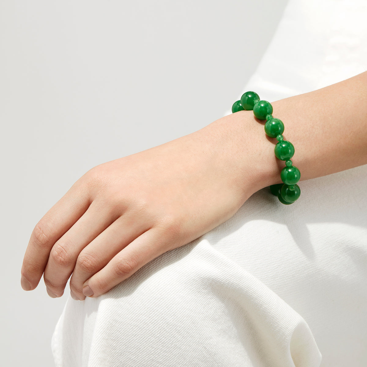 The 14K Yellow Gold Jade Beaded Bracelet, 202.00 TW, with large green beads and a gold clasp, is displayed on a white background.