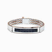 The Mens Sterling Silver and Rose Gold Black Sapphire Bracelet, 4.20 TCW, features a rectangular centerpiece with rows of black sapphires on silver and rose gold links, displayed against a white background.