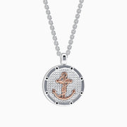 The Mens Sterling Silver and 18K Rose Gold Plated Anchor Pendant features a round, textured silver design with a rose gold anchor at the center, hanging from a sleek silver chain—part of our mens jewelry collection.