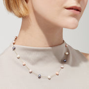 The 14K Yellow Gold Cultured Fresh Water Pearl 16.5 Necklace features evenly spaced white, pink, lavender, and dark blue pearls on a delicate yellow gold chain.