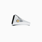 The Mens Sterling Silver and 18K Yellow Gold Onyx Ring, 5.90 TCW, features a large square black onyx centerpiece with 18K yellow gold accents on each side, shown against a plain white background.