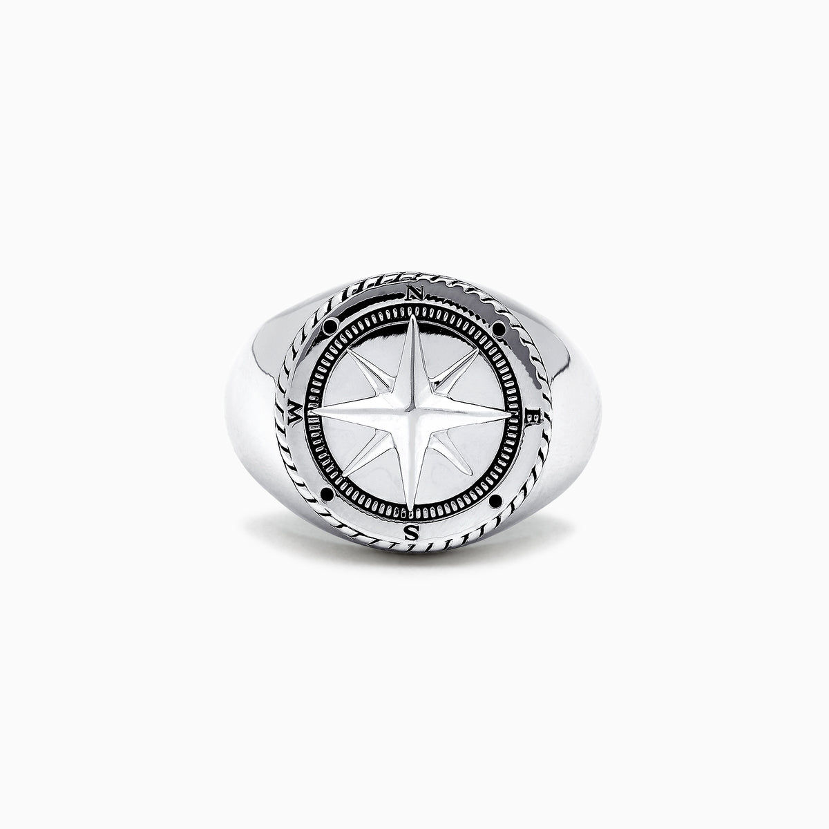 The Mens Sterling Silver Compass Ring showcases a detailed star at the center and engraved directional markers (N, E, S, W) around the edge. Its striking design is highlighted against a plain white background.