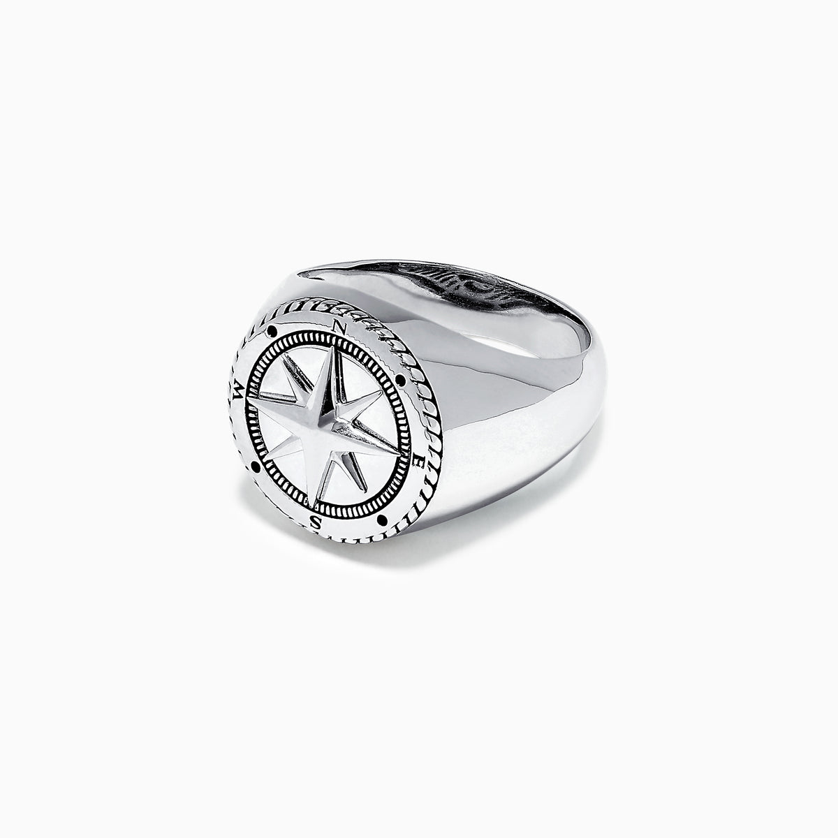 The Mens Sterling Silver Compass Ring showcases a detailed star at the center and engraved directional markers (N, E, S, W) around the edge. Its striking design is highlighted against a plain white background.