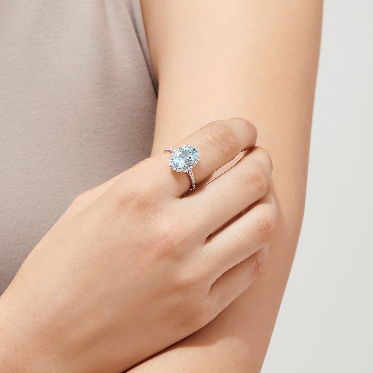 The Aquarius 14K White Gold Aquamarine and Diamond Ring, 3.45 TCW, showcases a large oval aquamarine center with a halo of sparkling round diamonds and additional diamonds along the sleek white gold band.