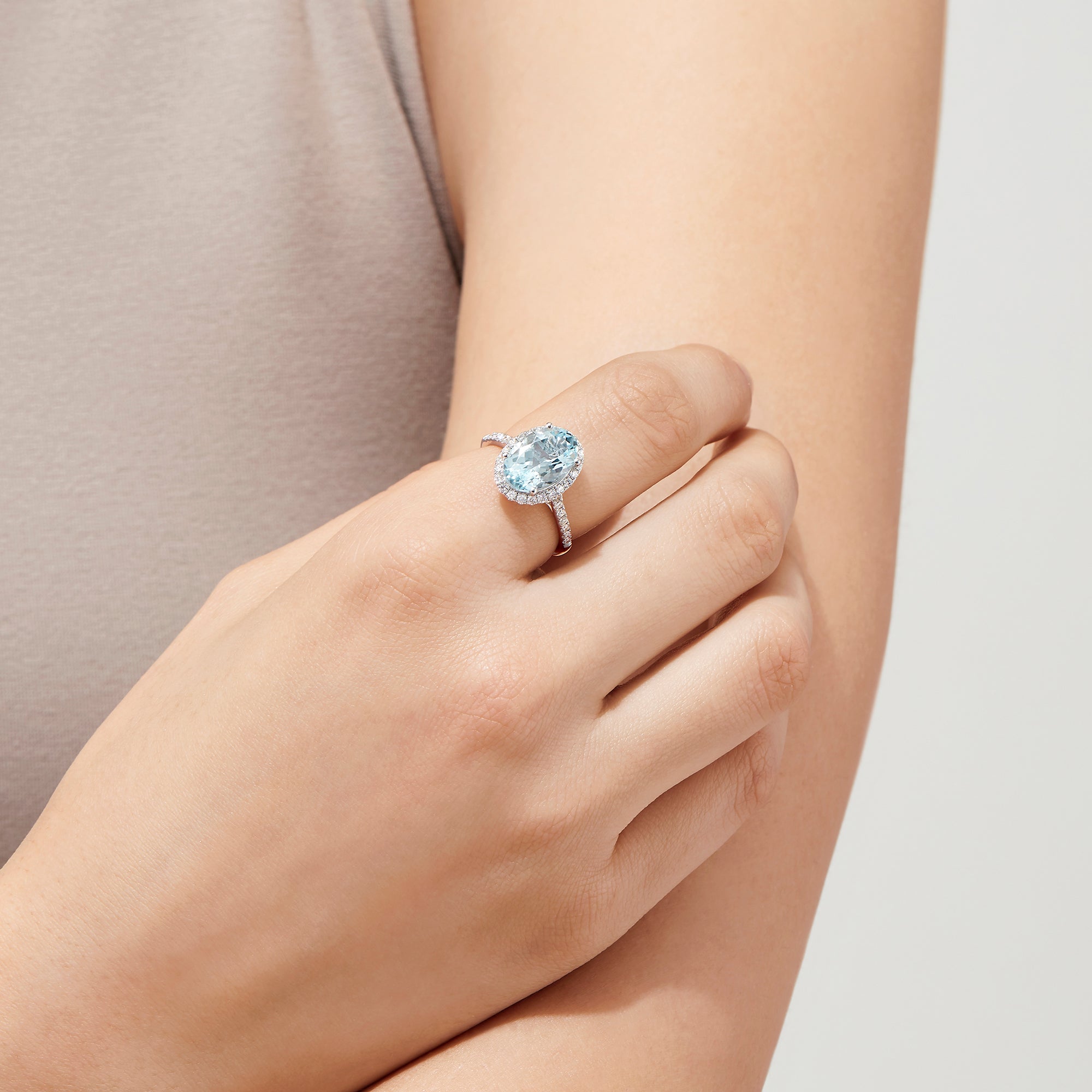 The Aquarius 14K White Gold Aquamarine and Diamond Ring, 3.45 TCW, showcases a large oval aquamarine center with a halo of sparkling round diamonds and additional diamonds along the sleek white gold band.