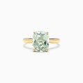 The 14K Yellow Gold Green Amethyst Ring features a 3.95 TCW rectangular cushion-cut gemstone set in a simple four-prong setting, shown against a white background.