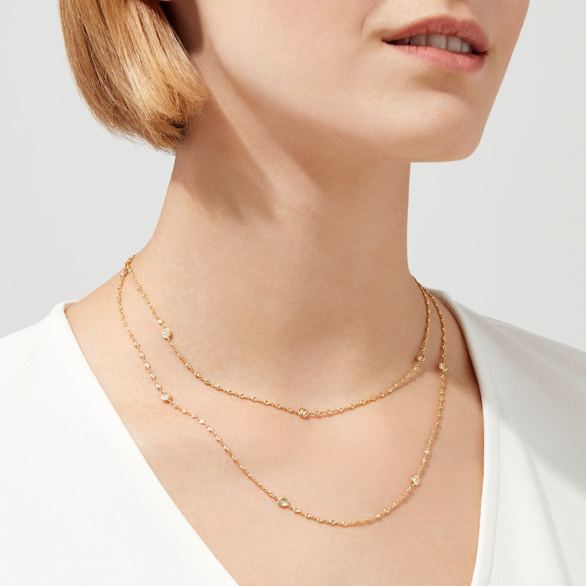 The DOro 14K Yellow Gold Diamond Station Necklace, 1.35 TCW, features small round diamonds spaced evenly along double layers for an elegant, minimalist style.