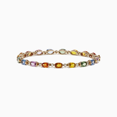 The Watercolors 14K Yellow Gold Sapphire and Diamond Bracelet, 11.20 TCW, features oval sapphires and gemstones in blue, green, yellow, orange, pink, and red evenly spaced around a delicate gold band.