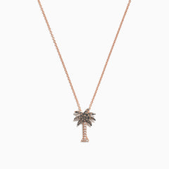 A Novelty 14K Rose Gold Diamond Palm Tree Pendant (0.10 TCW) necklace is shown on a delicate chain, with sparkling stones, displayed against a white background.