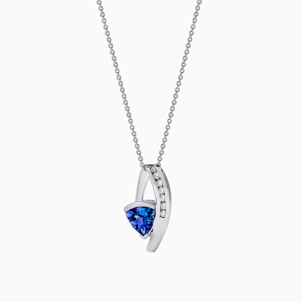 The Nahla Siri 14K White Gold Tanzanite & Diamond Pendant (1.73 TCW) features a curved design with sparkling diamonds and a striking triangular tanzanite, shown against a white background.