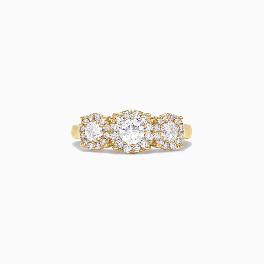 The Bouquet 14K Yellow Gold Three-Stone Diamond Halo Ring, 1.01 TCW, showcases three round diamonds with sparkling halos set in a thick gold band, displayed on a plain white background.