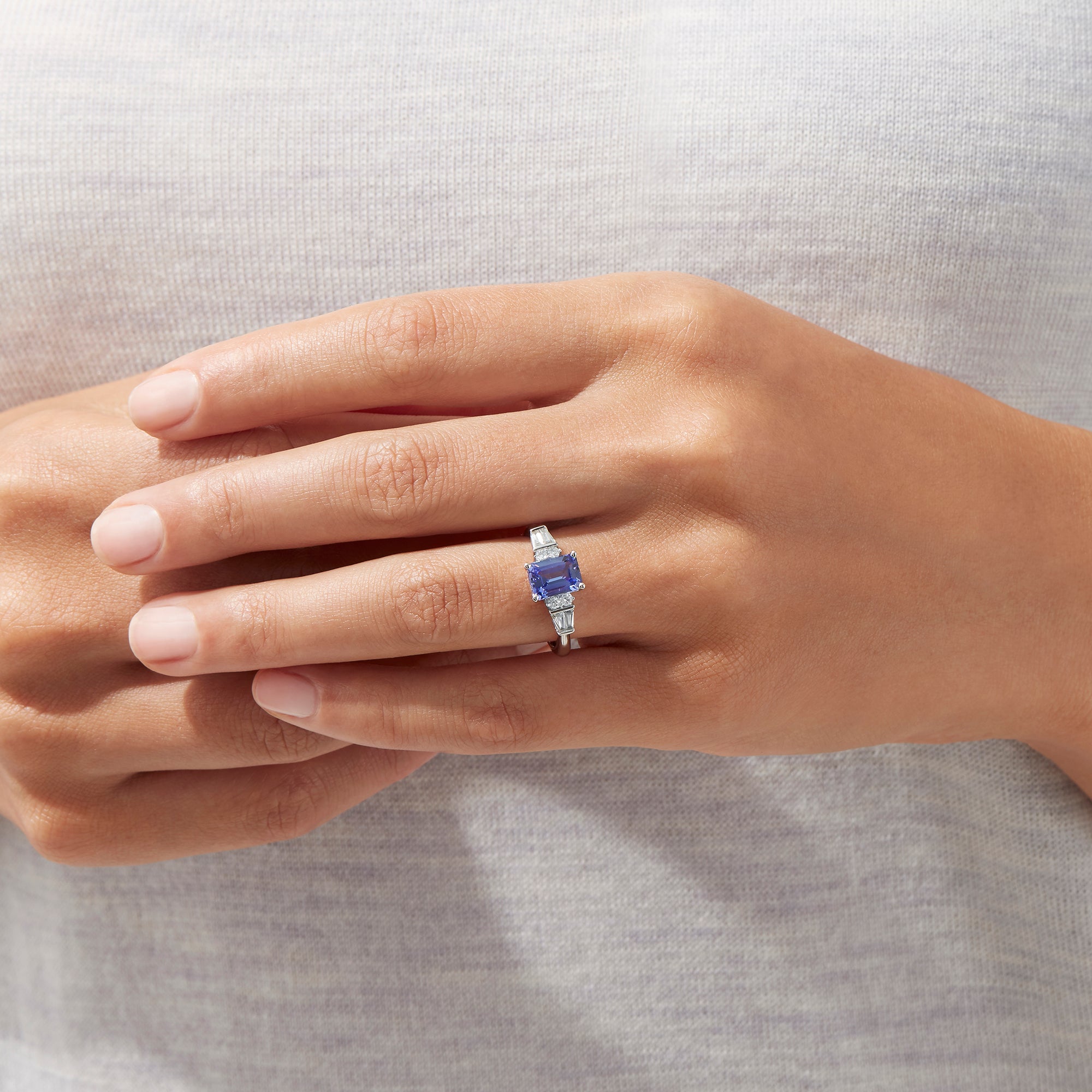 The Nahla Siri 14K White Gold Tanzanite and Diamond Ring, 1.51 TCW, features a rectangular tanzanite center stone accented by two small diamonds and tapered baguette diamonds on each side, set on a polished band.