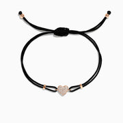 The Novelty 14K Rose Gold Diamond Heart String Bracelet features an adjustable black cord, a central rose gold heart with 0.13 TCW diamonds, and gold accents at the cords ends.