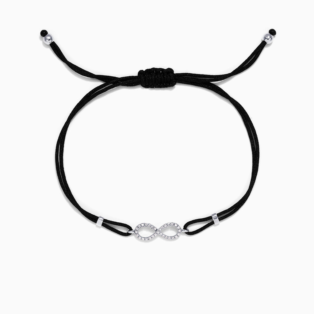 The Novelty 14K White Gold Diamond Infinity String Bracelet, 0.11 TCW, features a black adjustable cord with a diamond-studded infinity symbol at the center and silver bead accents at each end.