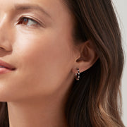 A pair of 14K white gold hoop earrings with black and white diamonds totaling 0.45 TCW, showcased against a plain white background. Effy craftsmanship enhances the modern elegance of this striking jewelry piece.