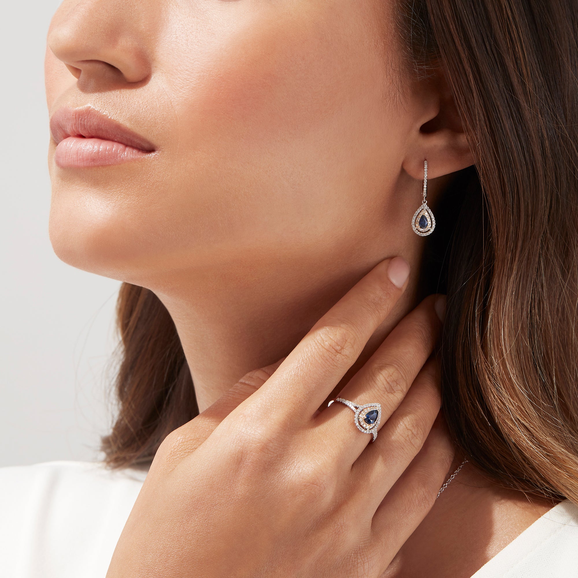 The Royale Bleu 14K Two Tone Gold Sapphire and Diamond Earrings, 0.93 TCW, feature sapphire teardrops encircled by diamonds, set in elegant two-tone gold and shown on a white background.