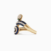 The Safari 14K Yellow Gold Blue Sapphire and Diamond Snake Ring, 1.49 TW, features a coiled serpent design with white and blue sapphires, green gemstone eyes, and is set against a plain white background.