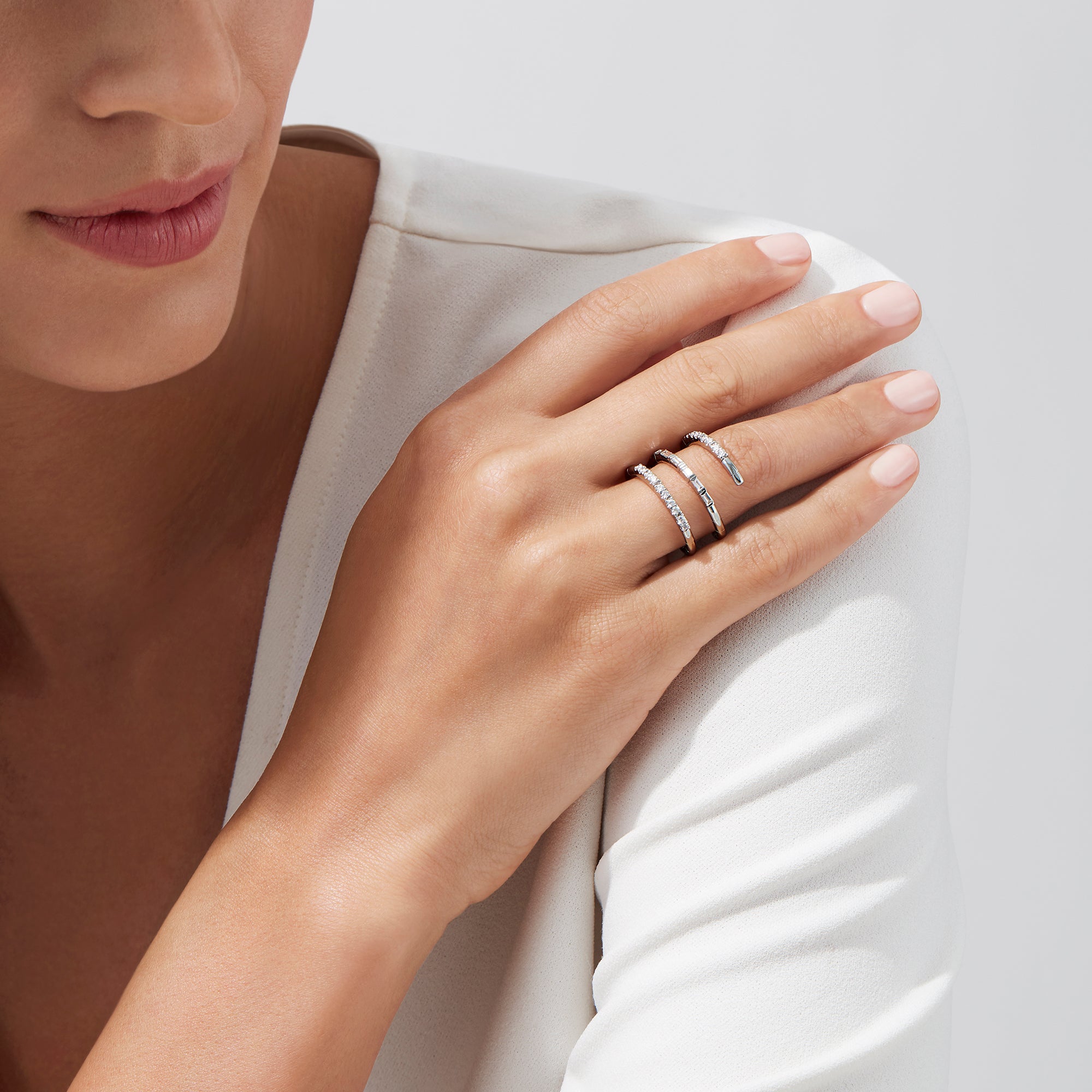 The Classique 14K White Gold Diamond Wrap Ring, 0.52 TCW, features sparkling diamonds along its elegant curves, showcased on a plain white background.