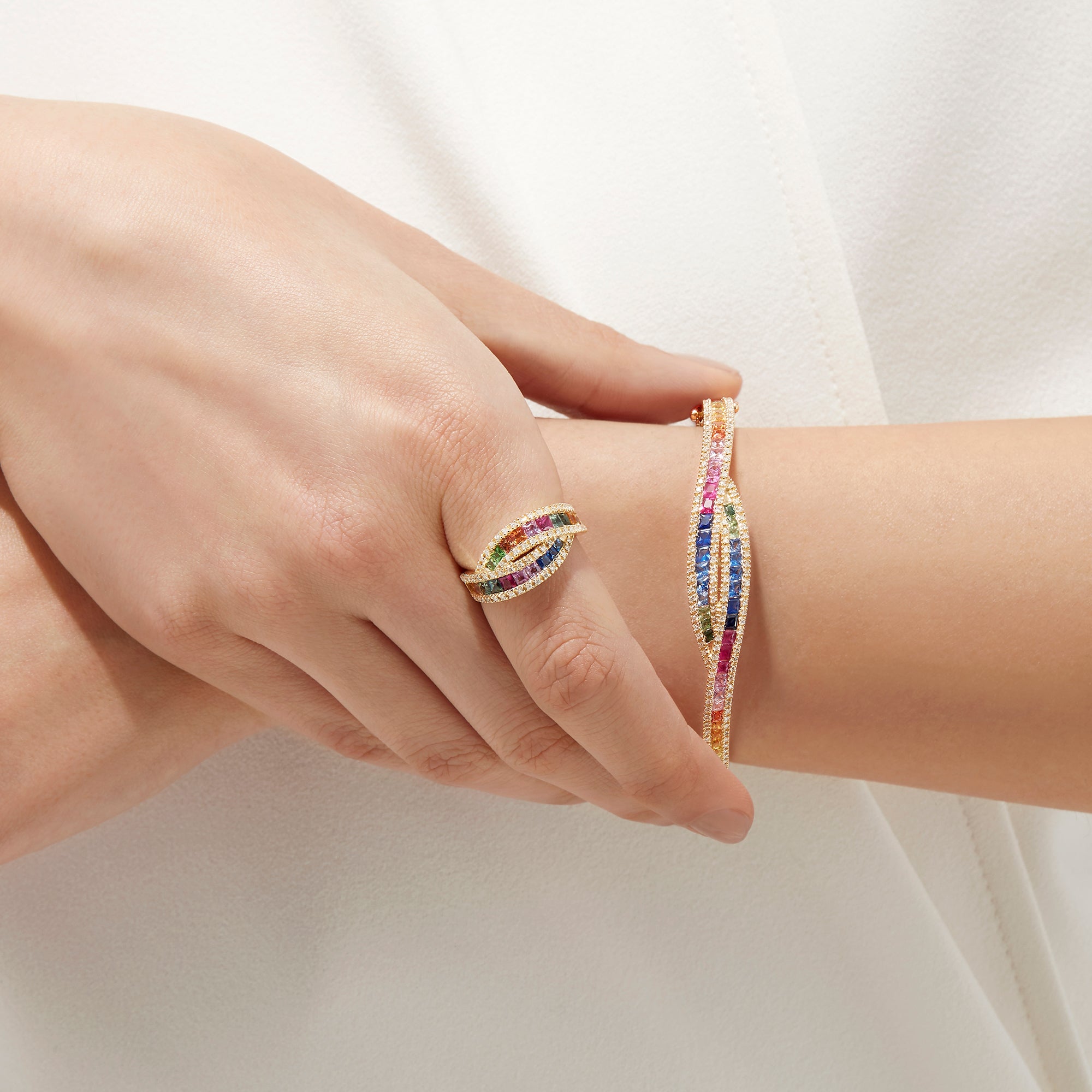 The Watercolors 14K Yellow Gold Multi Sapphire and Diamond Ring, 1.95 TCW, features two intertwined bands with square-cut sapphires and round white diamonds, set in yellow gold and shown on a white background.