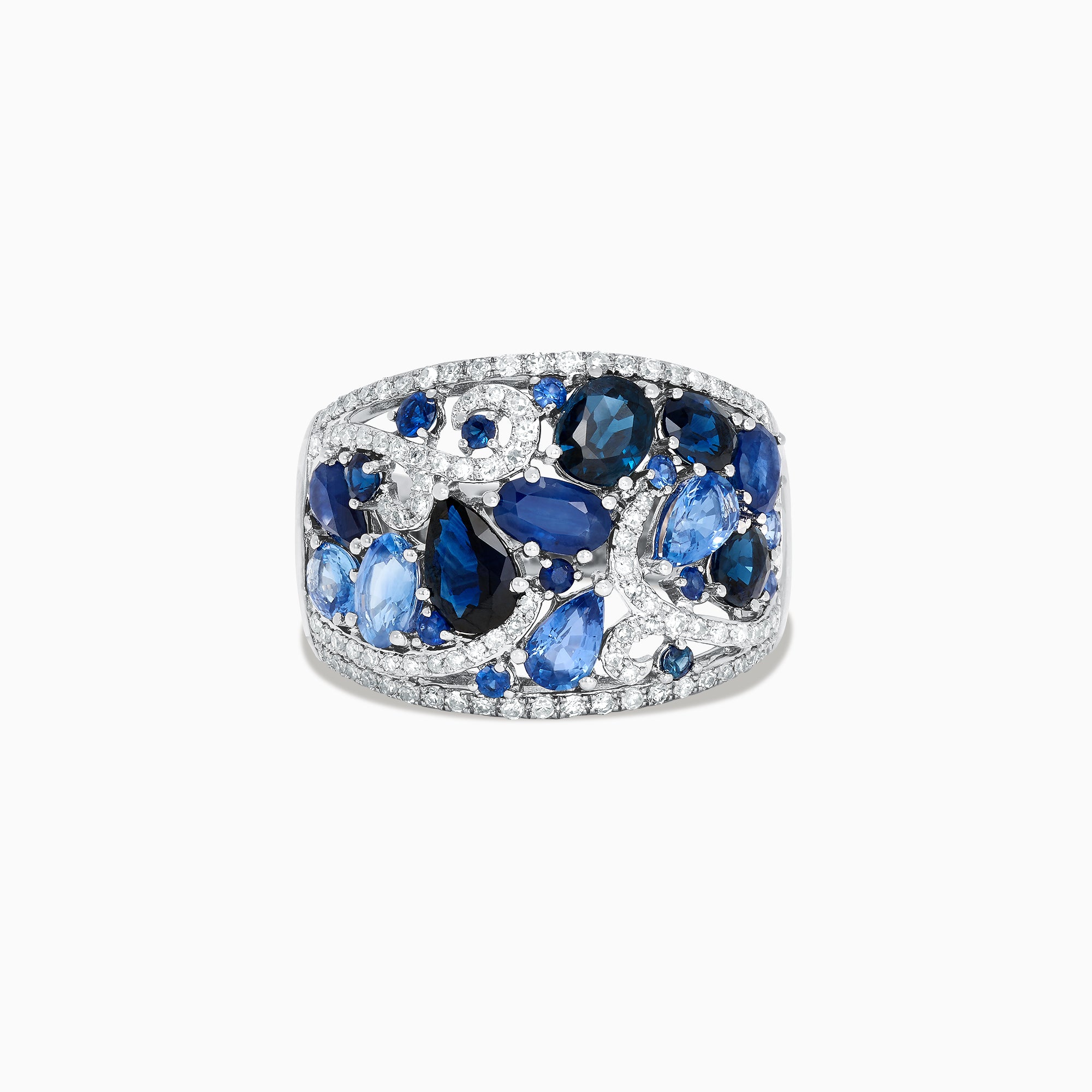 The 14K White Gold Blue Sapphire and Diamond Ring, 4.01 TCW, features sapphires in varied shapes and blue shades with sparkling white diamonds, all set in an intricate swirling design.