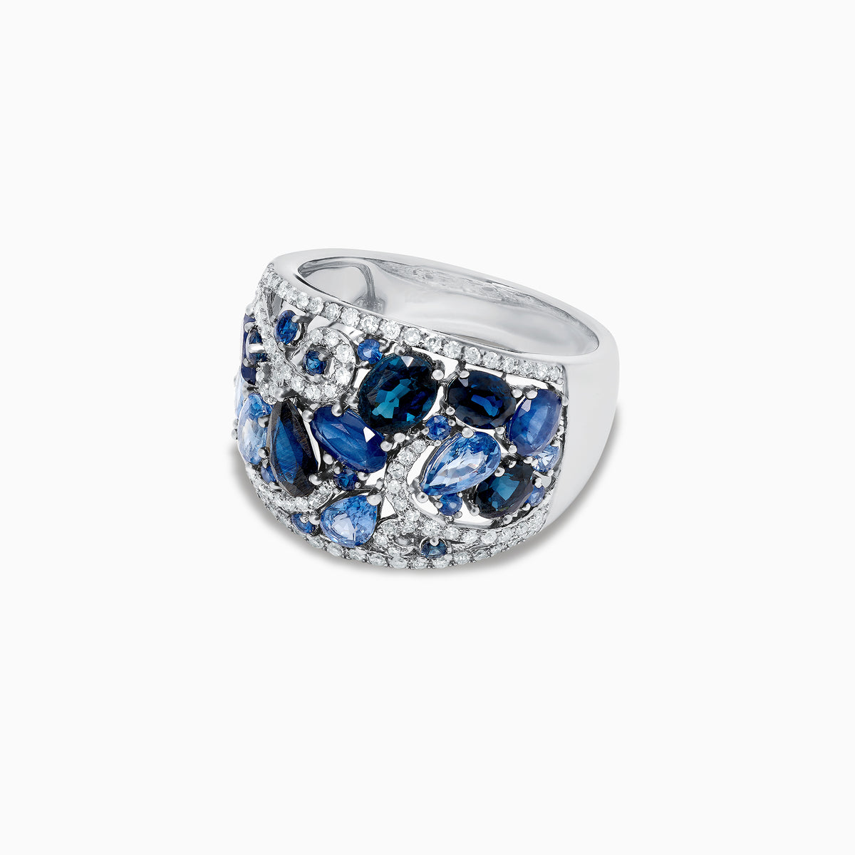 The 14K White Gold Blue Sapphire and Diamond Ring, 4.01 TCW, features sapphires in varied shapes and blue shades with sparkling white diamonds, all set in an intricate swirling design.