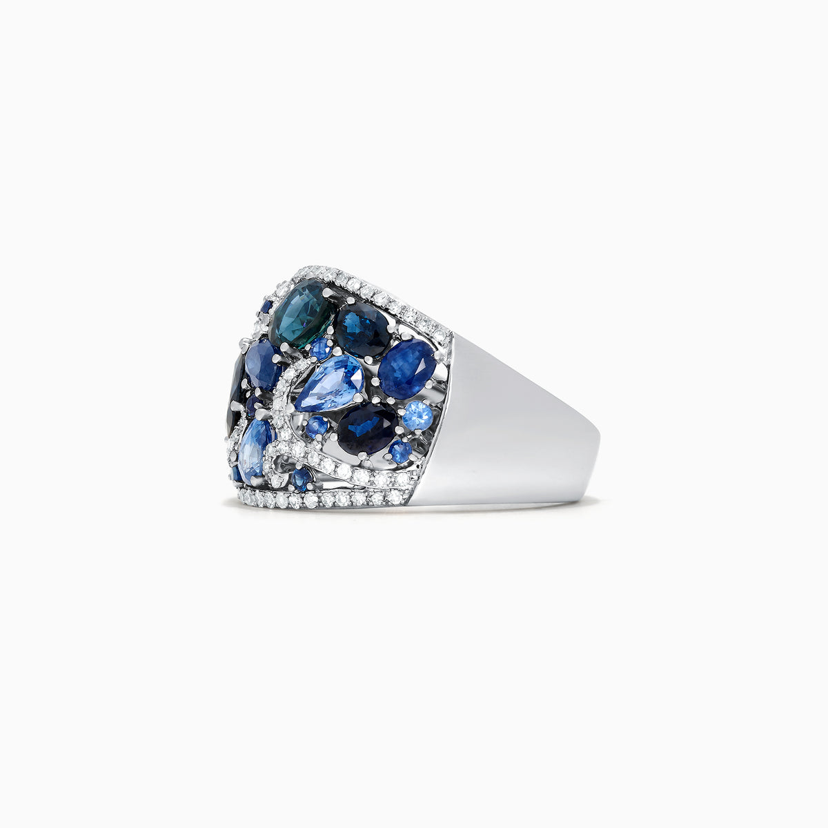 The 14K White Gold Blue Sapphire and Diamond Ring, 4.01 TCW, features sapphires in varied shapes and blue shades with sparkling white diamonds, all set in an intricate swirling design.