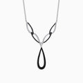 The 14K White Gold Black and White Diamond Necklace, 1.46 TCW, features an abstract teardrop pendant with intertwining black and silver loops, adorned with sparkling black and white diamonds.