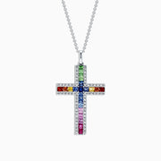 A 14K gold cross pendant, named Watercolors, features multi-colored sapphires and diamonds totaling 2.63 TCW, arranged in a vibrant grid pattern of blue, red, green, orange, and pink stones.