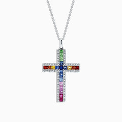 A 14K gold cross pendant, named Watercolors, features multi-colored sapphires and diamonds totaling 2.63 TCW, arranged in a vibrant grid pattern of blue, red, green, orange, and pink stones.