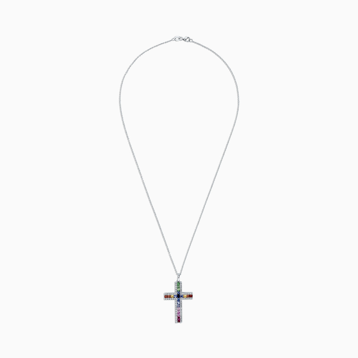 A 14K gold cross pendant, named Watercolors, features multi-colored sapphires and diamonds totaling 2.63 TCW, arranged in a vibrant grid pattern of blue, red, green, orange, and pink stones.