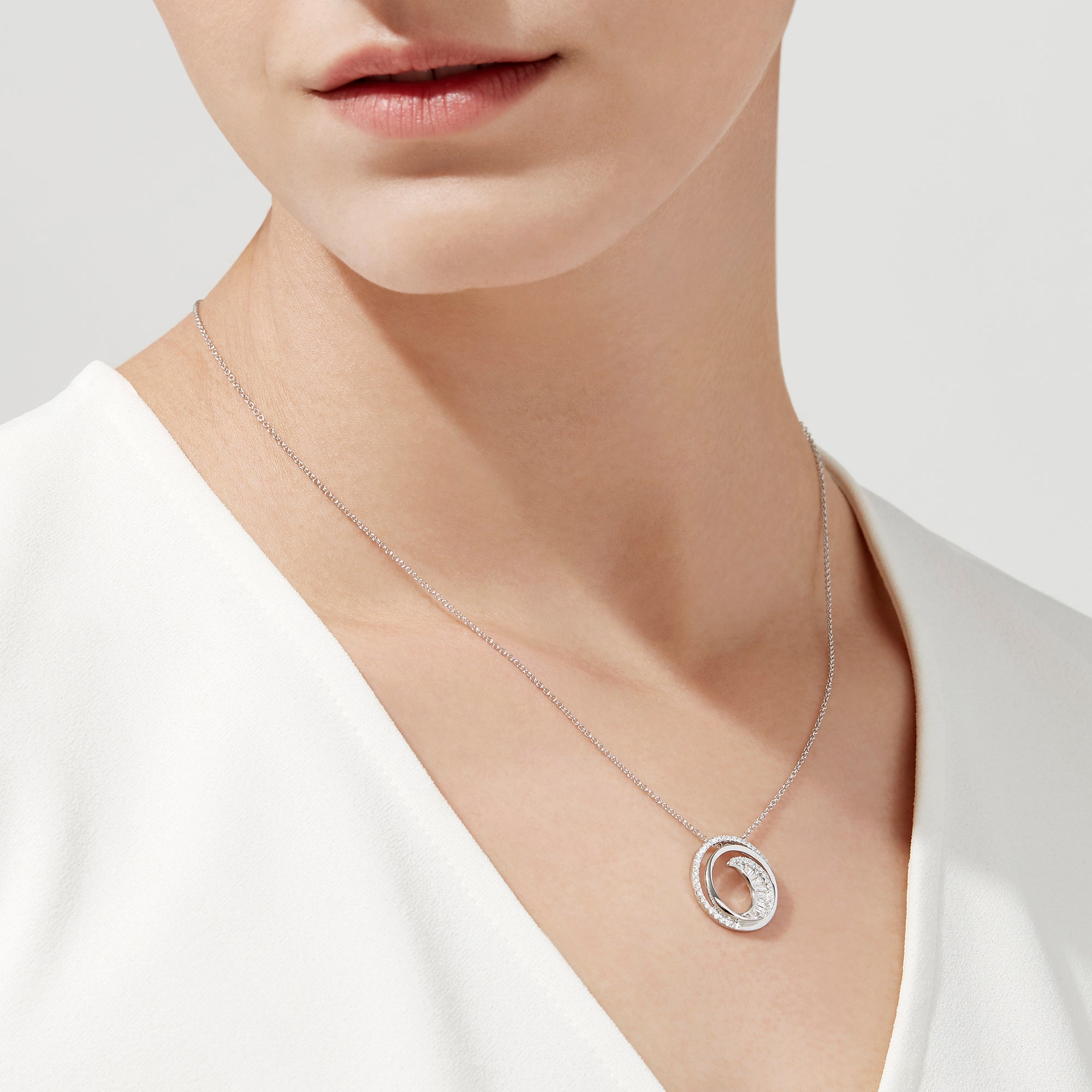 The Classique 14K White Gold Diamond Swirl Pendant (0.48 TCW) features a round swirl design with sparkling diamonds, inspired by Effy Classique and set on a delicate white gold chain for an elegant, modern style.