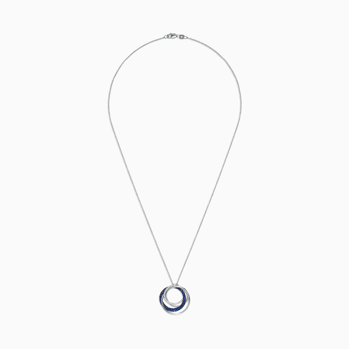 A 14K white gold necklace showcases a pendant of two interlocking circles—one with blue sapphires, the other with diamonds (0.74 TCW)—suspended from a delicate chain on a white background.