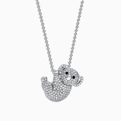 The Safari 14K White Gold Diamond Koala Bear Pendant, 0.69, features a charming koala sparkling with diamonds and black gemstone accents, elegantly hanging from a fine white gold chain.