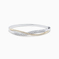 The 14K White and Yellow Gold Diamond Crossover Bangle features intertwined gold bands with sparkling diamonds totaling 2.00 TCW, and a hinged design for easy wear and a secure fit.