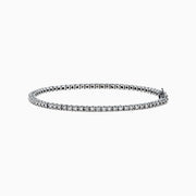 The 14K White Gold Diamond Tennis Bracelet, 1.51 TCW, features small, evenly spaced round diamonds set in delicate white gold and is displayed on a plain white background.