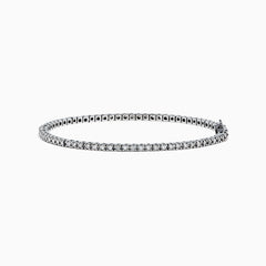 The 14K White Gold Diamond Tennis Bracelet, 1.51 TCW, features small, evenly spaced round diamonds set in delicate white gold and is displayed on a plain white background.