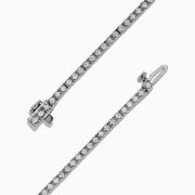 The 14K White Gold Diamond Tennis Bracelet, 1.51 TCW, features small, evenly spaced round diamonds set in delicate white gold and is displayed on a plain white background.