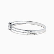 The Classique 14K White Gold Diamond Bangle (0.93 TCW) features a central rectangular emerald-cut diamond accented by smaller diamonds and double rows of pavé diamonds along the band.