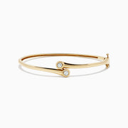 The DOro 14K Yellow Gold Diamond Two-Of-Us Bangle, 0.39 TCW, features two round diamond accents on the ends of overlapping bands, displayed against a white background.