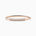 The 14K Rose Gold Diamond Pave Bangle, 1.00 TCW, features a rectangular diamond-encrusted section and is elegantly displayed on a plain white background.