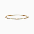 The DOro 14K Yellow Gold Diamond Bangle, 1.00 TCW features a slim design with a single row of sparkling white diamonds on the top curve, beautifully showcased against a white background.