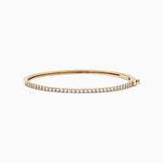 The DOro 14K Yellow Gold Diamond Bangle, 1.00 TCW features a slim design with a single row of sparkling white diamonds on the top curve, beautifully showcased against a white background.