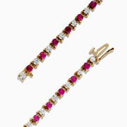 The 14K Yellow Gold Ruby and Diamond Tennis Bracelet, 3.85 TCW, showcases alternating round rubies and white diamonds set in a single elegant row.