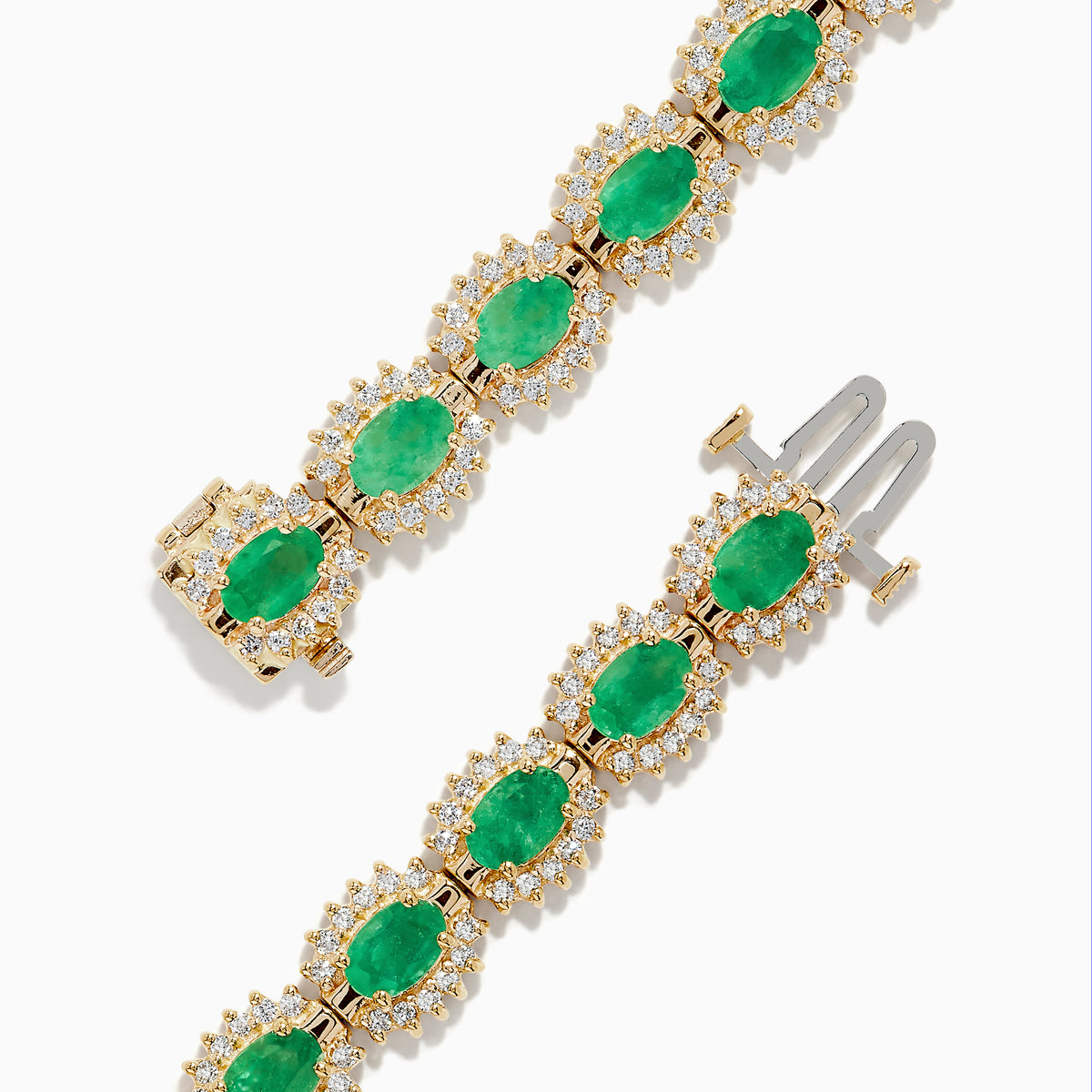 The 14K Yellow Gold Emerald and Diamond Tennis Bracelet showcases oval emeralds framed by diamonds in a classic tennis bracelet design.