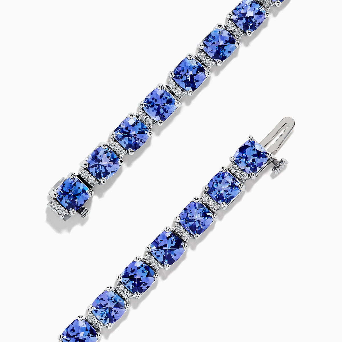 The Nahla Siri 14K White Gold Tanzanite & Diamond Tennis Bracelet, 14.74 TCW, showcases prong-set square-cut tanzanites and diamonds in a sleek row, elegantly displayed on a white background.