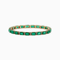The Brasilica 14K Yellow Gold Emerald & Diamond Tennis Bracelet, 11.76 TCW, features a row of rectangular emeralds in prong settings, accented by diamonds. Elegantly showcased on a white background.